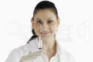 Smiling female doctor preparing a syringe