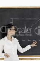 Dark-haired teacher explaining charts to students