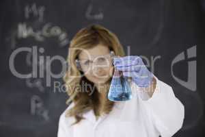 Cute female scientist carrying out an experiment