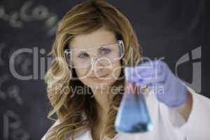 Attractive female scientist carrying out an experiment