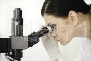 Scientist looking through a microscope in a lab