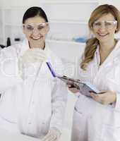 Two scientists with a test tube and a notepad