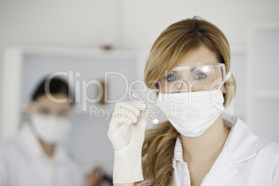 Blond-haired scientist looking at the camera in a lab