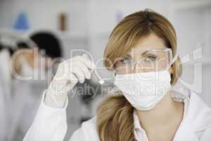 Attractive scientist woman looking at the camera in a lab