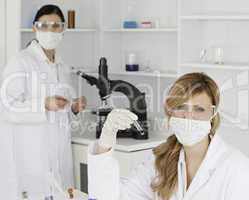 Blond-haired and dark-haired scientists carrying out an experime