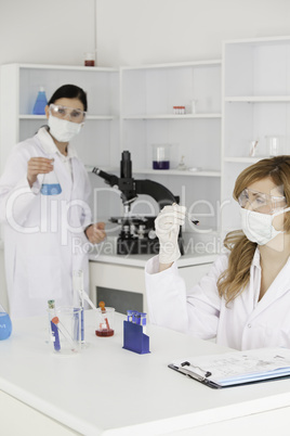 Scientists wearing masks and safety glasses