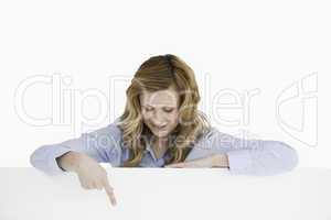 Attractive blond-haired woman standing behind an empty white boa