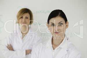 Two cute women in front of a white board