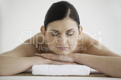 Dark-haired woman relaxing while lying down