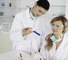 Female scientists looking at a test tube