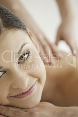 Cute dark-haired woman enjoying a massage