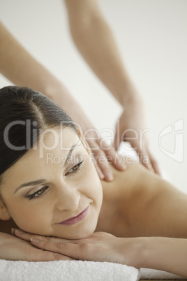 Attractive dark-haired woman enjoying a massage