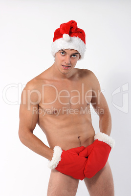 Sexy muscular man wearing a Santa Claus hat