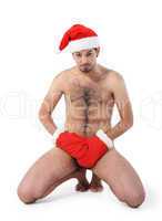 Sexy muscular man wearing a Santa Claus hat isolated on white