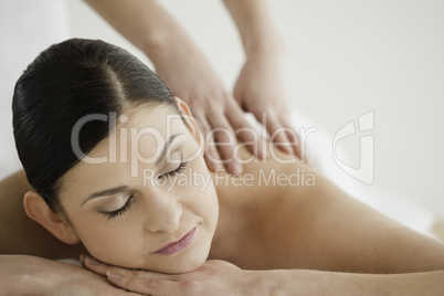 Lovely dark-haired woman enjoying a massage