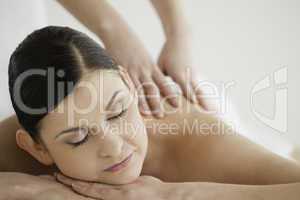 Lovely dark-haired woman enjoying a massage