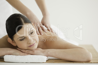 Pretty dark-haired woman enjoying a massage