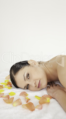 Attractive brunette lying down and receiving a massage
