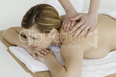 Cute blond-haired woman getting a massage