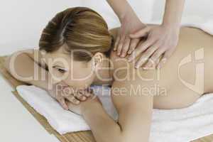 Cute blond-haired woman getting a massage