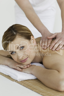 Attractive blond-haired woman getting a massage