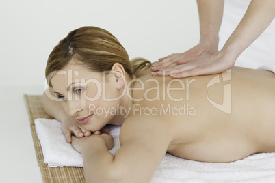 Young and attractive blond-haired woman getting a massage