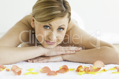 Pretty blond-haired woman happy while lying down