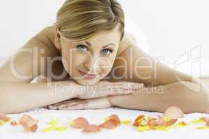 Pretty blond-haired woman happy while lying down