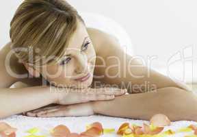 Young blond-haired woman happy while lying down