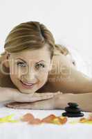 Beautiful blond-haired woman looking at the camera while lying d