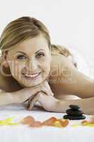 Pretty blond-haired woman looking at the camera while lying down