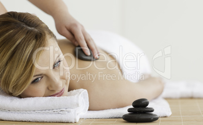Therapist making a massage to a beautiful blond-haired woman
