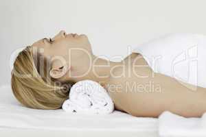 Cute blond-haired woman receiving a spa treatment