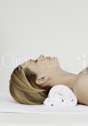 Attractive blond-haired woman receiving a spa treatment