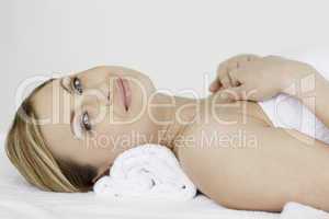 Attractive blond-haired woman lying down