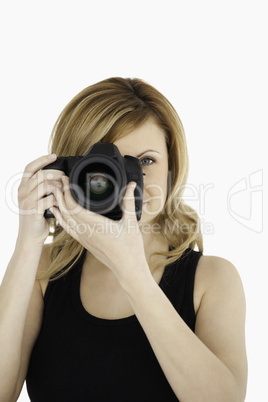 Attractive blond-haired woman taking a photo with a camera