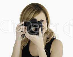 Blond-haired woman taking a photo with a camera