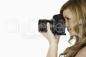 Pretty blond-haired woman taking a photo with a camera