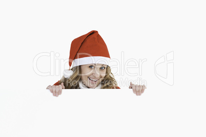 Smiling blond-haired woman dressed as Santa Claus