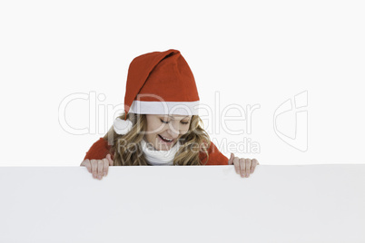 Happy blond-haired woman dressed as Santa Claus