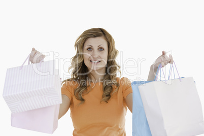 Cute blond-haired woman showing her shopping
