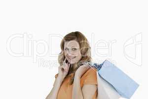 Lovely blond-haired woman showing her shopping