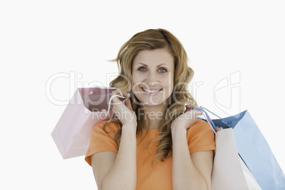 Happy blond-haired woman showing her shopping