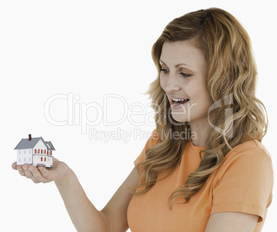 Young woman holding an house model