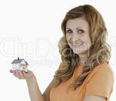 Cute woman holding an house model