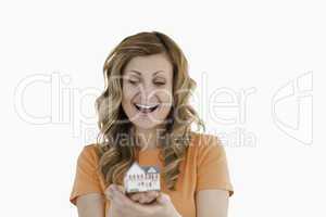 Happy woman holding an house model