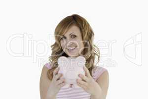 Cute woman posing while holding her piggybank