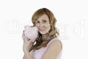 Cute woman posing with her piggybank