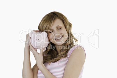 Cute woman happy with her piggybank