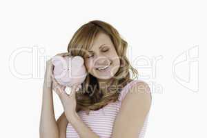 Cute woman happy with her piggybank